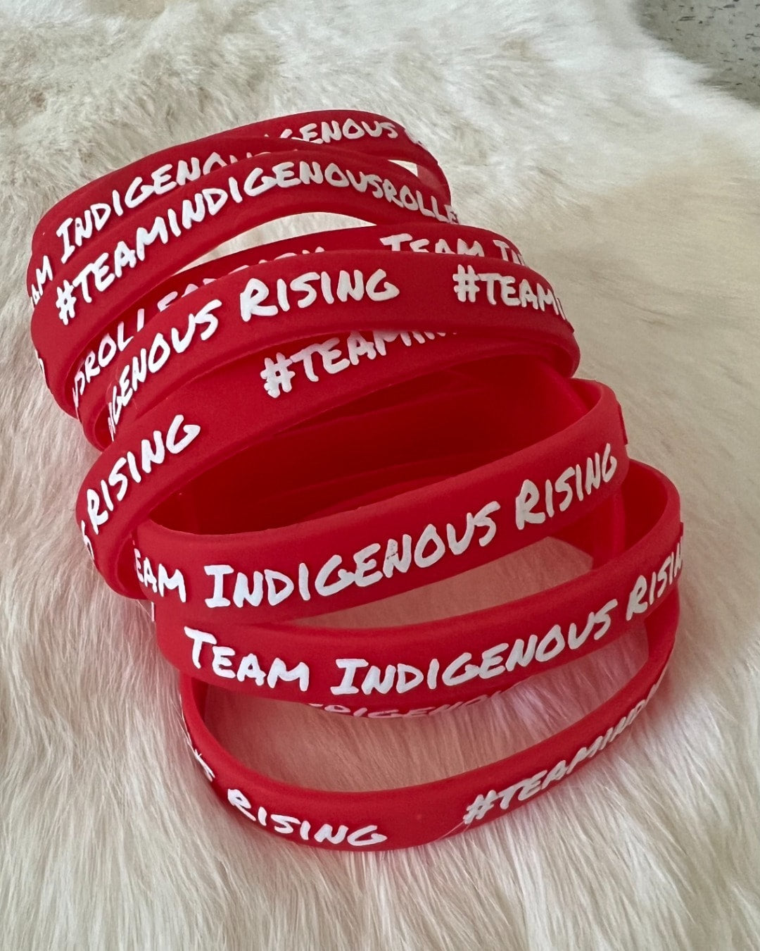 Team Indigenous Rising Roller Derby, red rubber bracelet