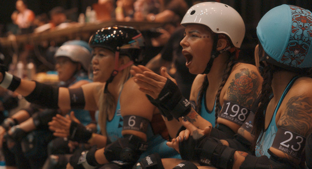 Indigenous Rising Roller Derby skater's cheer for each other at a tournament.