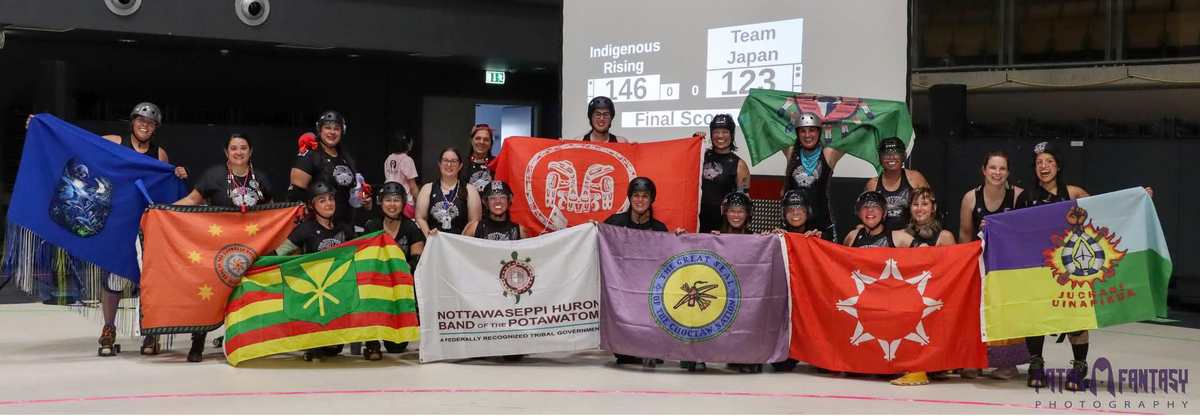 Indigenous Rising Roller Derby representing their team/national flags at the Roller Derby World Cup in July 2025 after their win against Team Japan.
