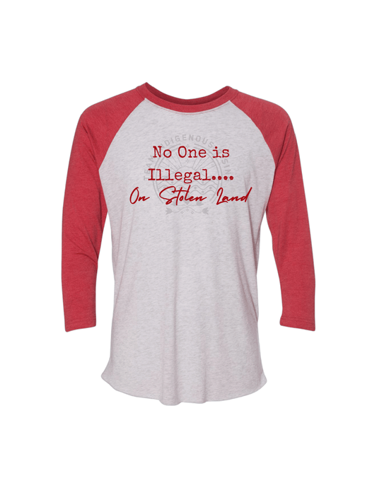 A 3/4 sleeve raglan baseball t-shirt with a heather gray body and red sleeves, featuring the text 'No One is Illegal on Stolen Land'